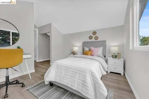 a bedroom with a bed a couch and a window