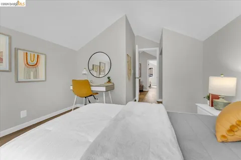 a bedroom with bed and a chandelier