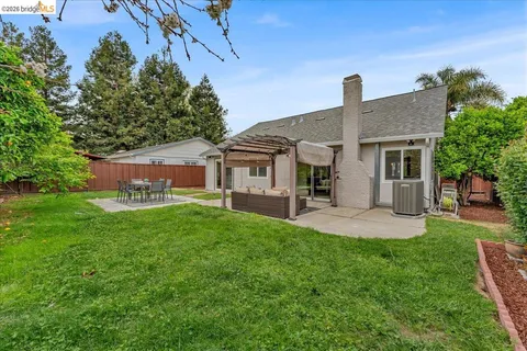a front view of a house with a garden and yard