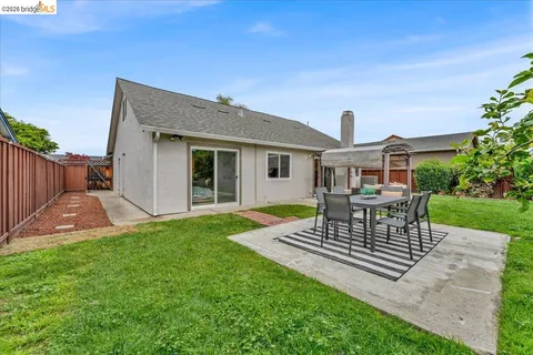 a view of a house with a yard and sitting area