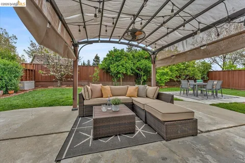 a view of a patio with a table and chairs