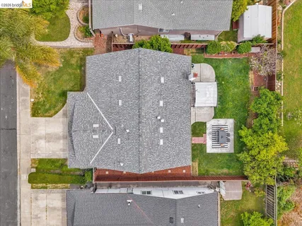 an aerial view of a house with a yard and pool