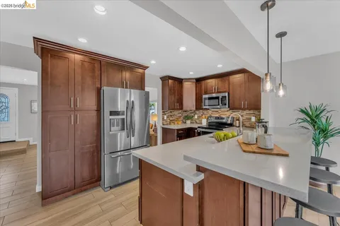 a kitchen with a refrigerator a sink and cabinets