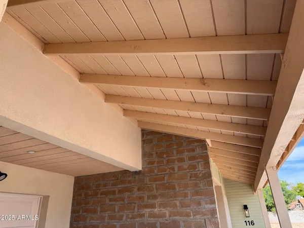 a kitchen with a refrigerator and white cabinets