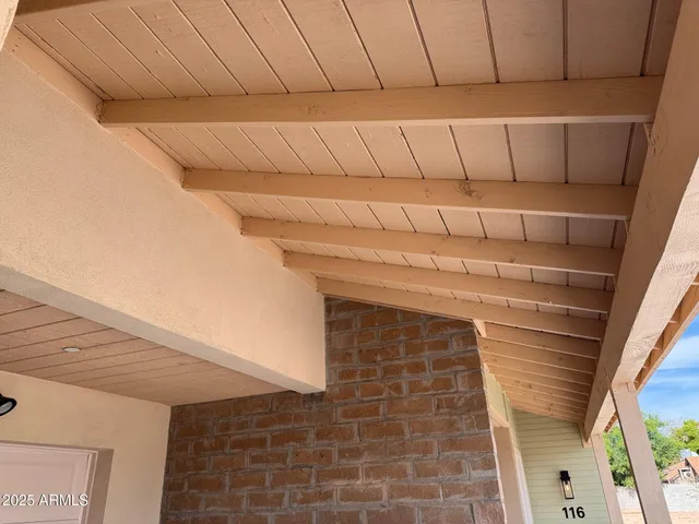 a kitchen with a refrigerator and white cabinets