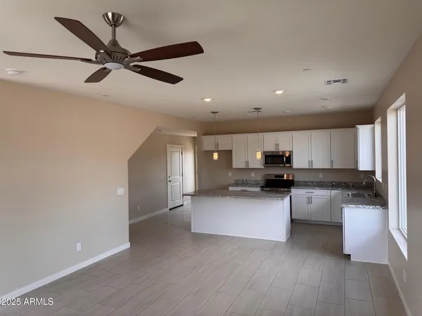 a kitchen with kitchen island cabinets and wooden floor