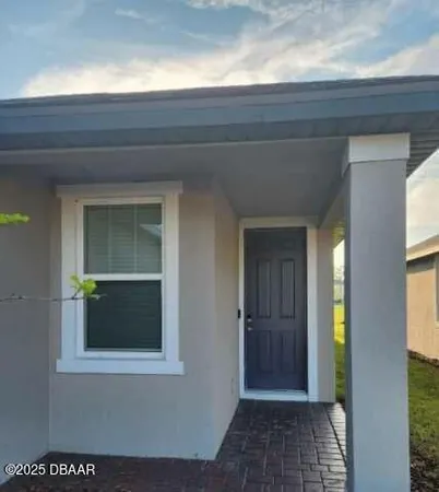 a view of a hallway that has front door