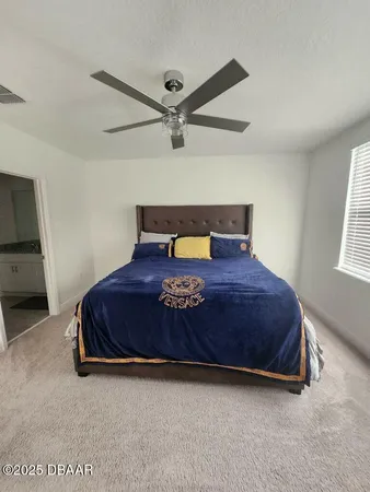 a bed sitting in a bedroom next to a window