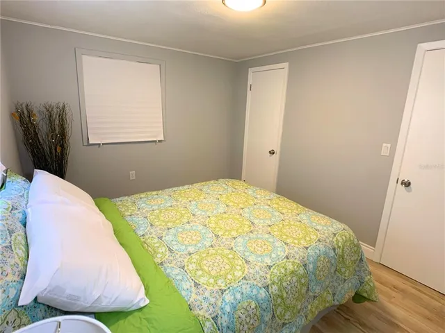 a bed sitting in a bedroom next to a window