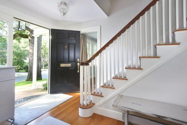 76 Alban Road Newton, MA 02468 - Photo 11 of 19 a view of staircase with lots of frames on wall and a large window