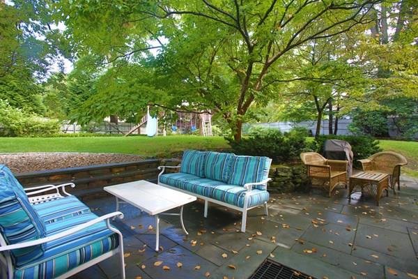 76 Alban Road Newton, MA 02468 - Photo 18 of 19 a view of a patio with table and chairs and a barbeque