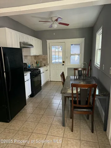 a kitchen with a sink a counter top space and stainless steel appliances
