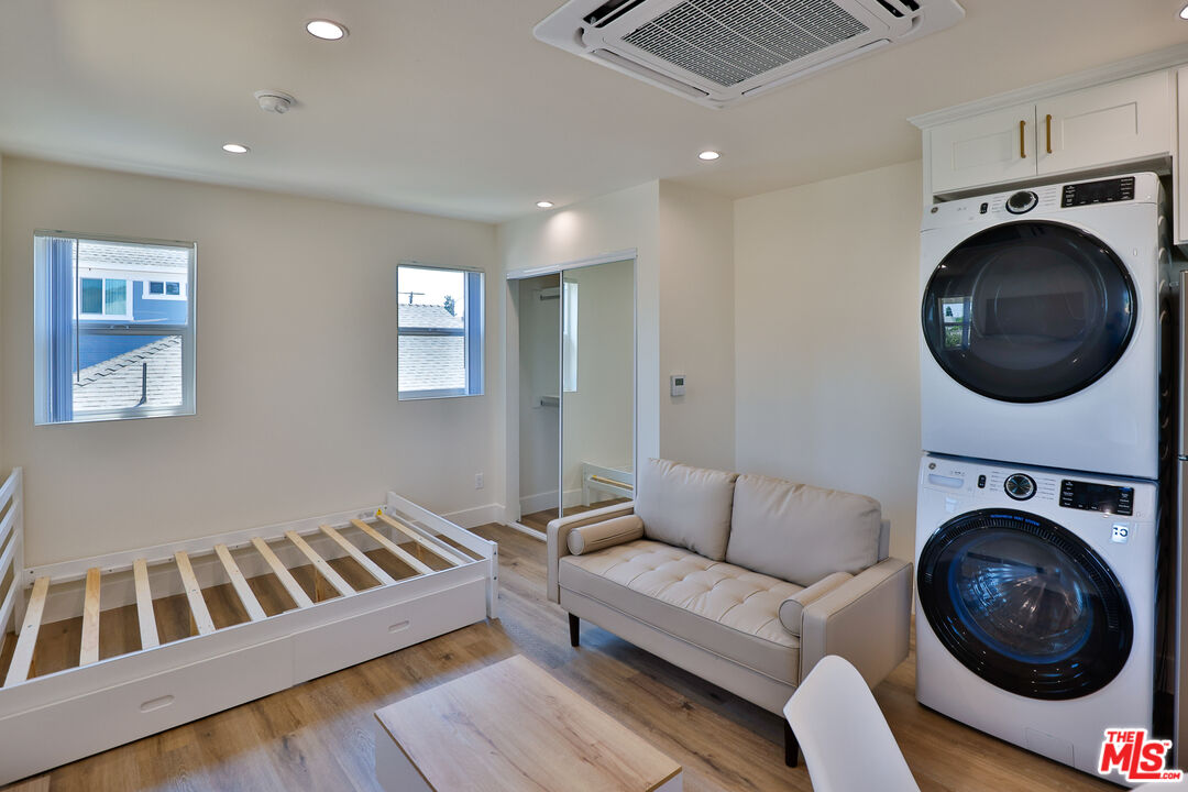 1237 West 25th Street, Unit 1241 1/2 Los Angeles, CA 90007 - Photo 12 of 16 a living room with furniture and a wooden floor
