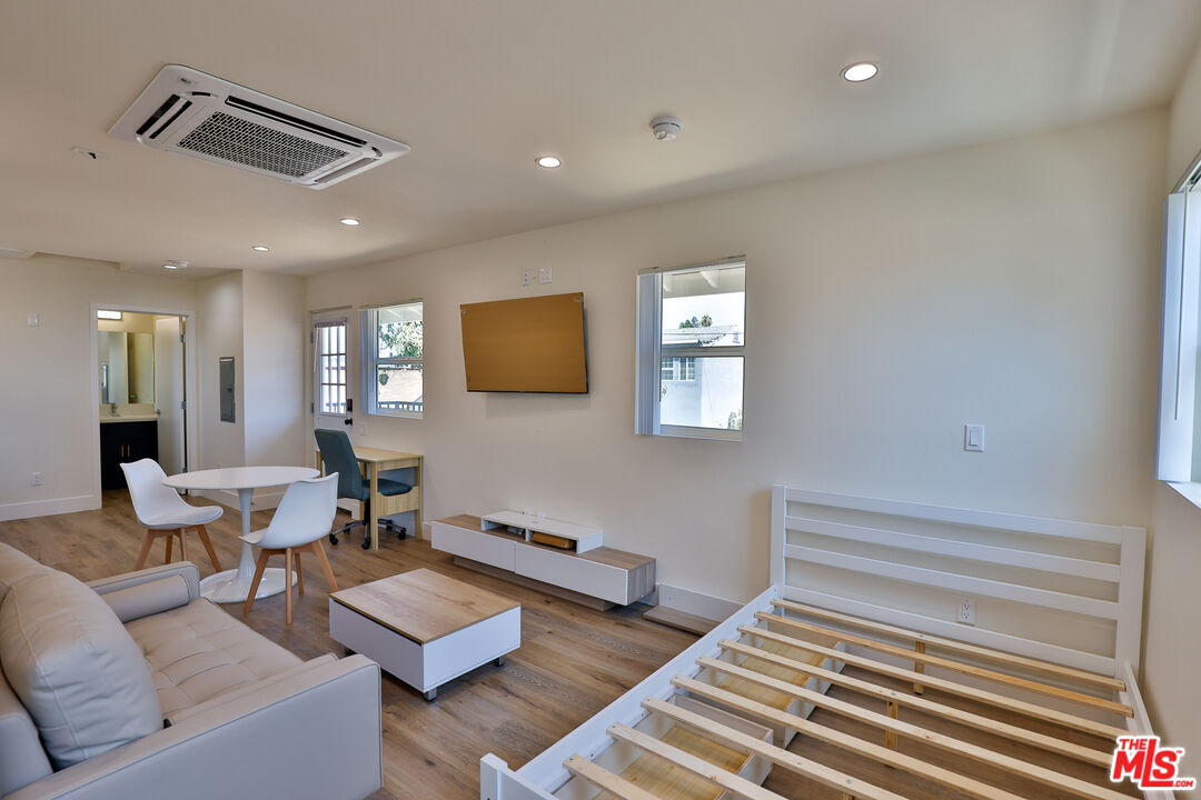 1237 West 25th Street, Unit 1241 1/2 Los Angeles, CA 90007 - Photo 9 of 16 a living room with couches and a flat screen tv