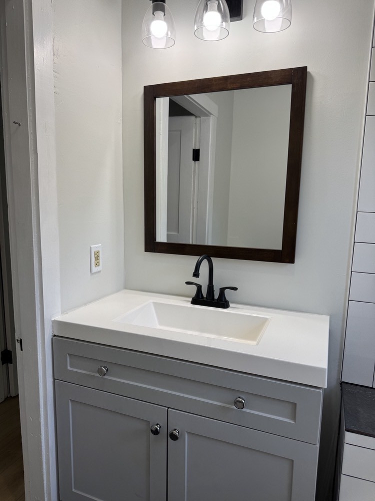 143 Morrison Street, Unit 1 Gallatin, TN 37066 - Photo 11 of 12 a bathroom with a sink and a mirror