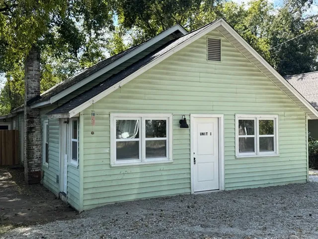 a kitchen with granite countertop white cabinets and stainless steel appliances