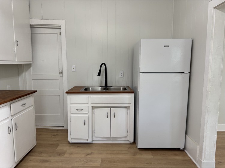 143 Morrison Street, Unit 1 Gallatin, TN 37066 - Photo 4 of 12 a kitchen with a refrigerator sink stove and cabinets