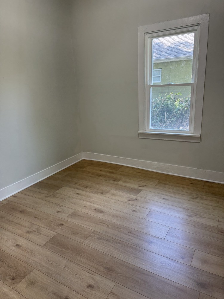 143 Morrison Street, Unit 1 Gallatin, TN 37066 - Photo 8 of 12 an empty room with wooden floor and windows