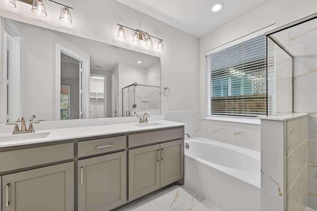4123 Windy Point Court Oak Point, TX 75068 - Photo 2 of 29 Bathroom featuring a dual vanity with grey cabinetry, white countertops, and brushed nickel fixtures