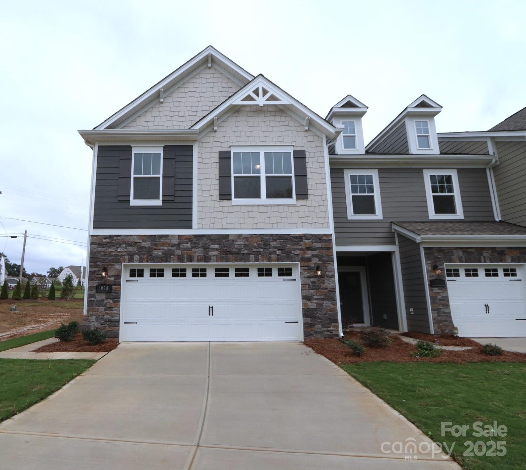 1008 Overbrook Place Wingate, NC 28174 - Photo 1 of 18 a front view of a house with a yard and a garage
