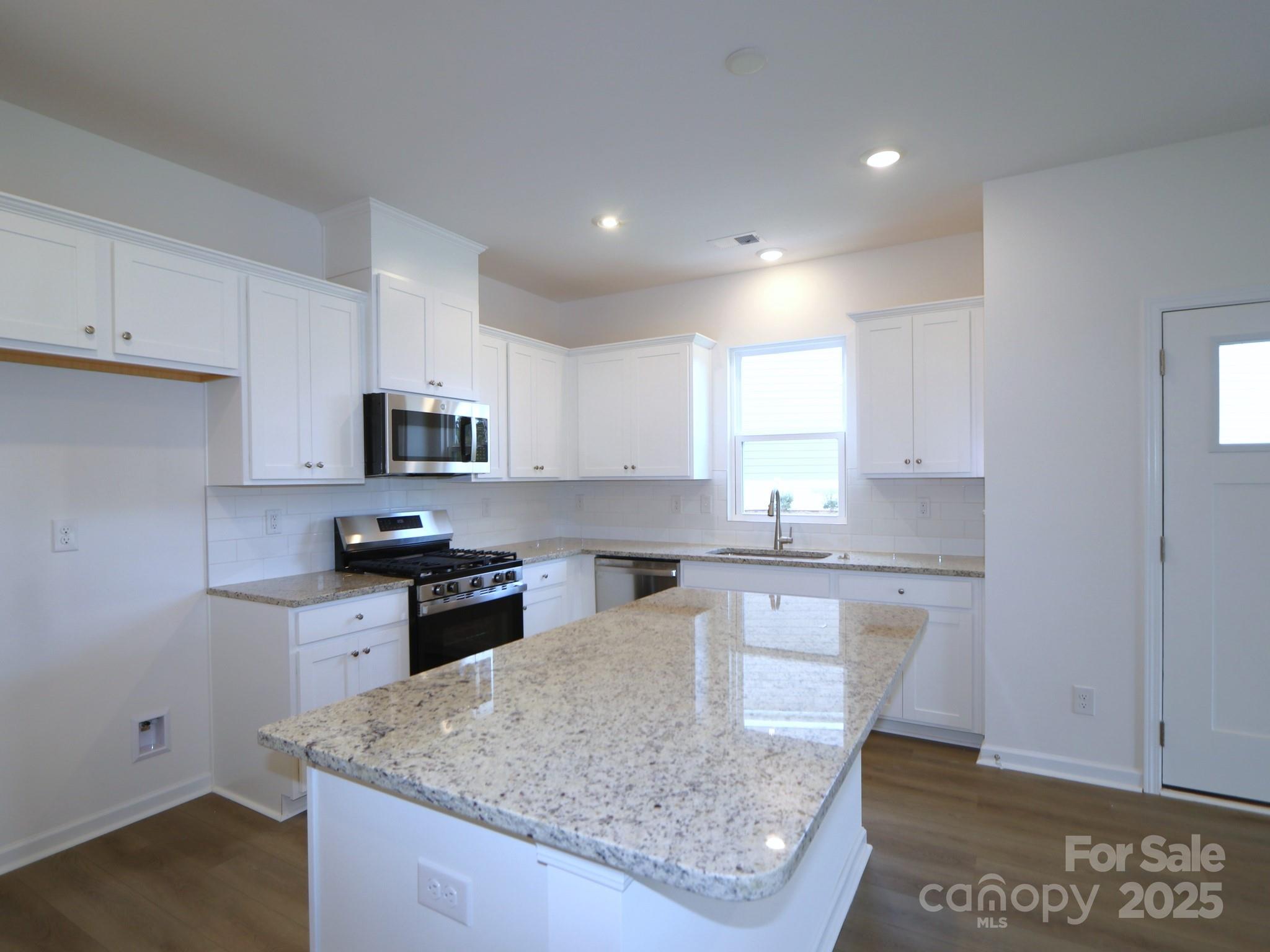 1008 Overbrook Place Wingate, NC 28174 - Photo 3 of 18 a kitchen with stainless steel appliances granite countertop a sink stove and refrigerator