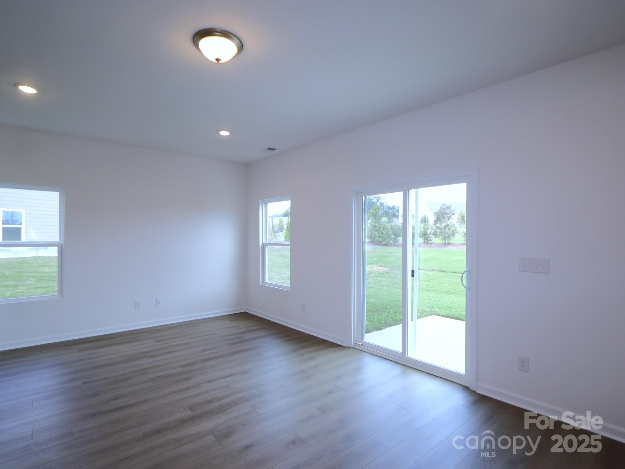 1008 Overbrook Place Wingate, NC 28174 - Photo 8 of 18 an empty room with wooden floor and windows