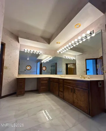 a large bathroom with a large tub and sink