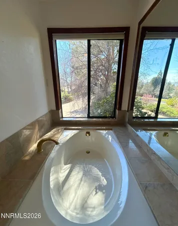 an empty room with closet and a bathroom