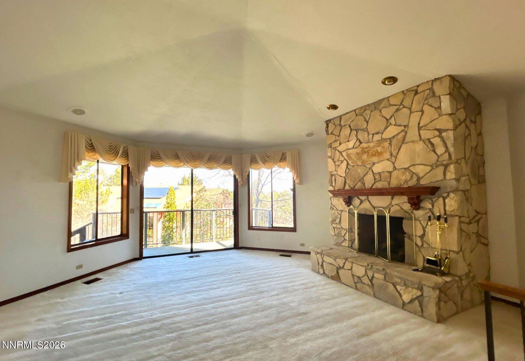 2795 West Lake Ridge Reno, NV 89519 - Photo 10 of 31 a view of an empty room with a fireplace and a window