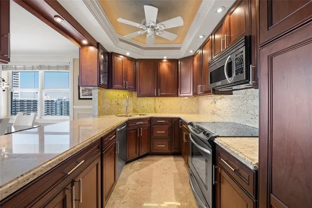 a kitchen with stainless steel appliances granite countertop a refrigerator and a sink