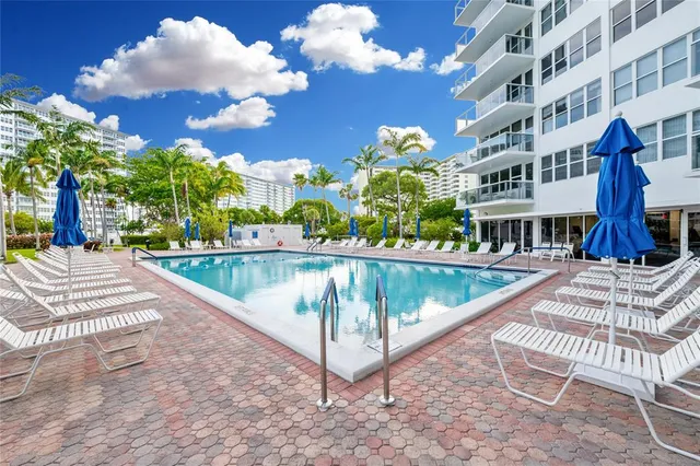a view of a swimming pool with a lounge chairs