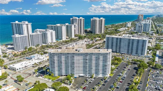a bathroom with a granite countertop sink a toilet a mirror and shower