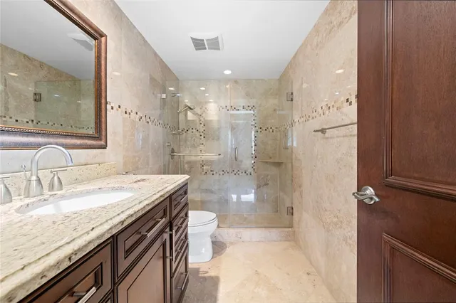 a bedroom with a large bed and a chandelier