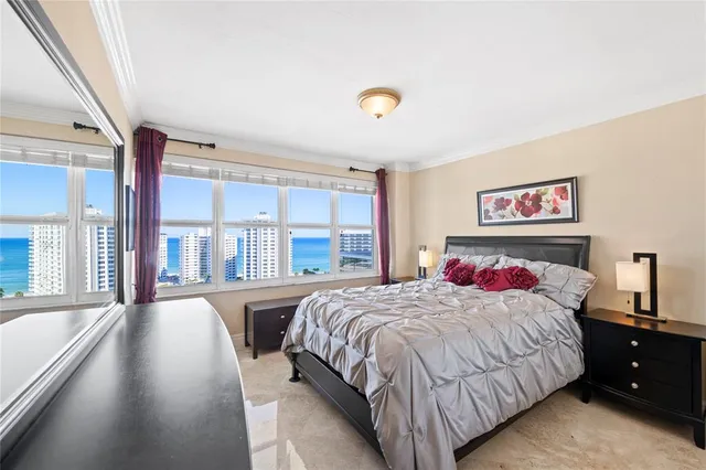 a living room with furniture a rug and a potted plant