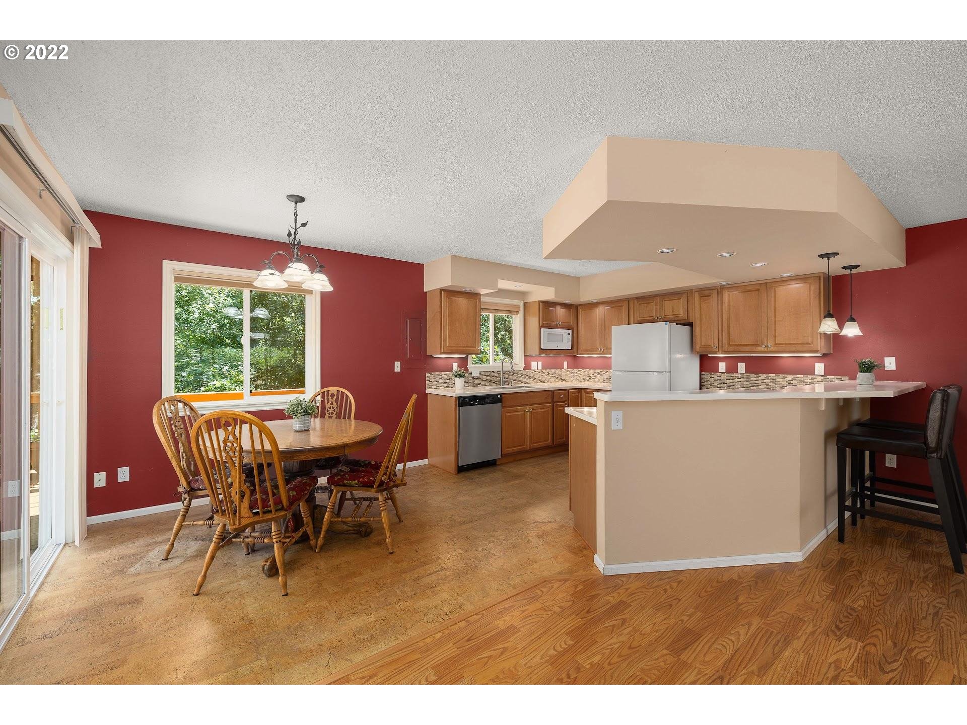 4416 Northwest Barnes Road Portland, OR 97210 - Photo 6 of 23 a view of a dining room with furniture and chandelier