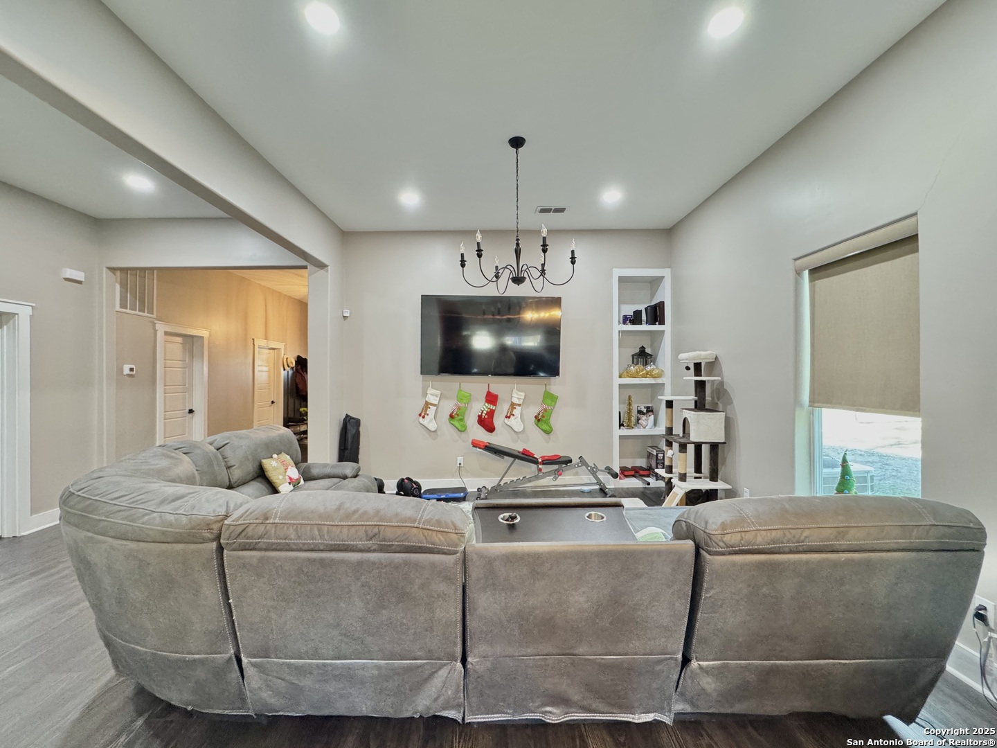1106 North High Street Uvalde, TX 78801 - Photo 12 of 26 a living room with a couch and a flat screen tv