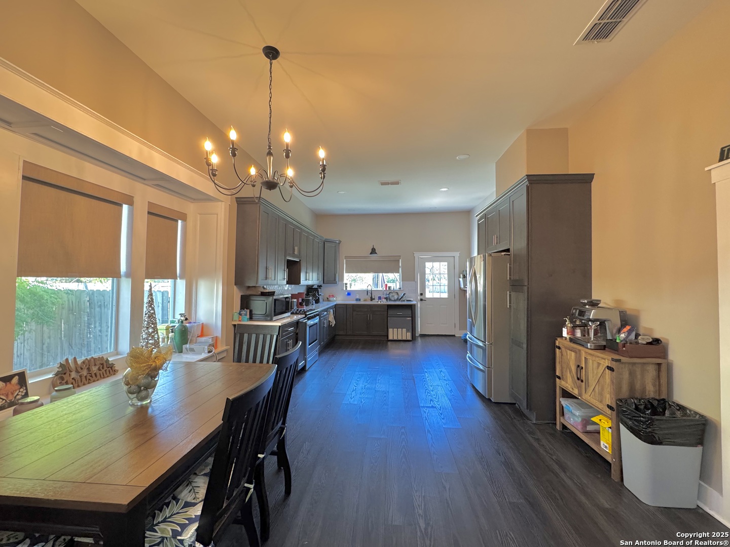 1106 North High Street Uvalde, TX 78801 - Photo 13 of 26 a view of a dining room with furniture and wooden floor