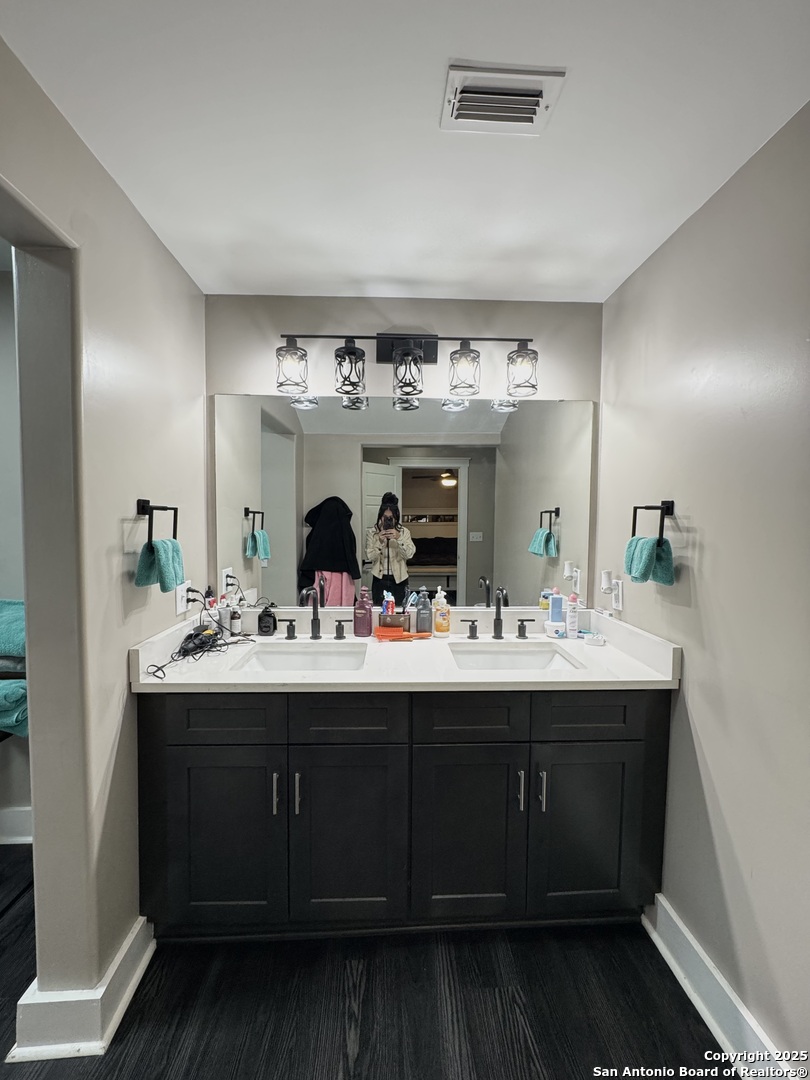 1106 North High Street Uvalde, TX 78801 - Photo 19 of 26 a view with double vanity sink and mirror