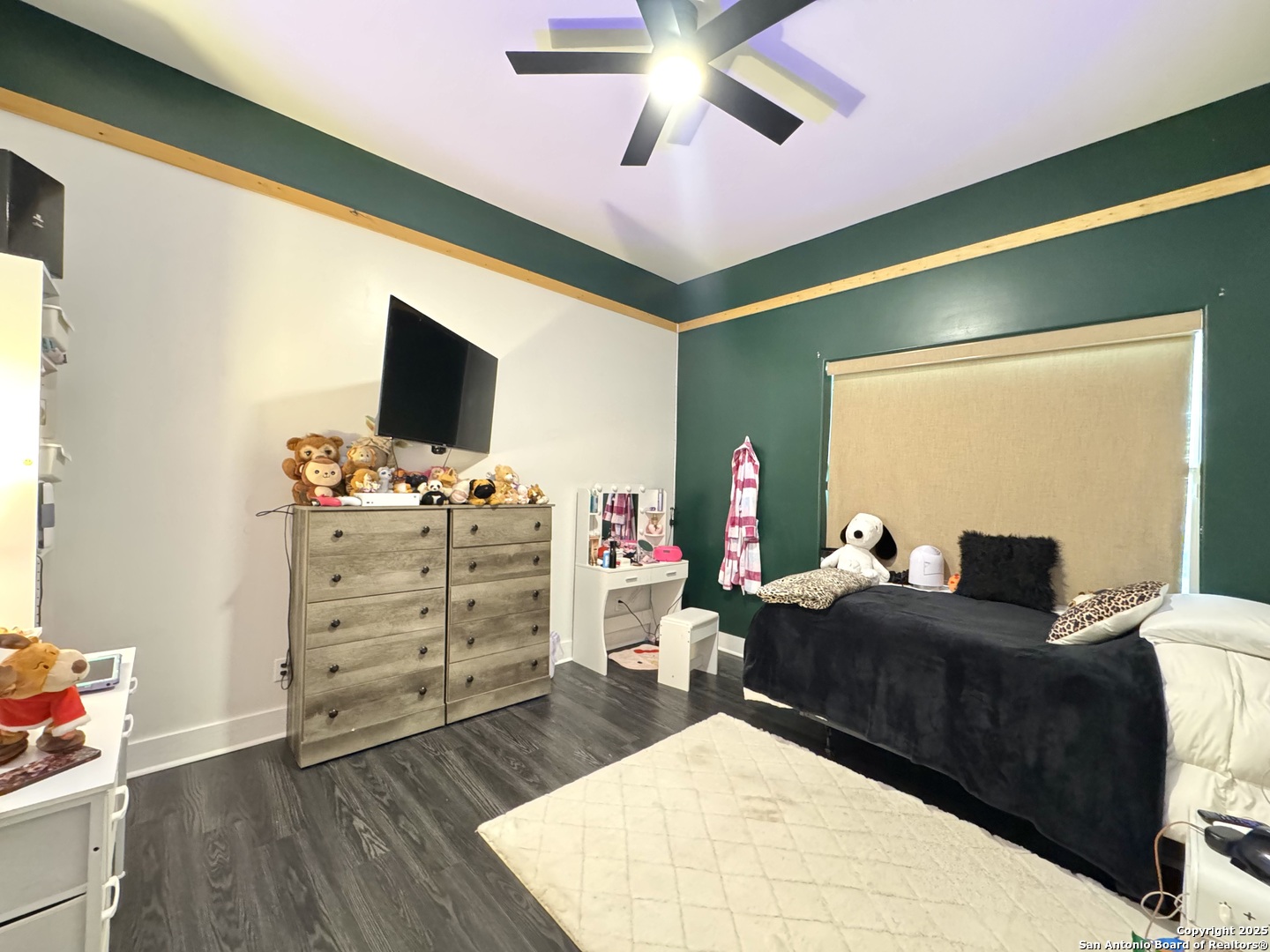 1106 North High Street Uvalde, TX 78801 - Photo 4 of 26 a bedroom with a bed and wooden floor