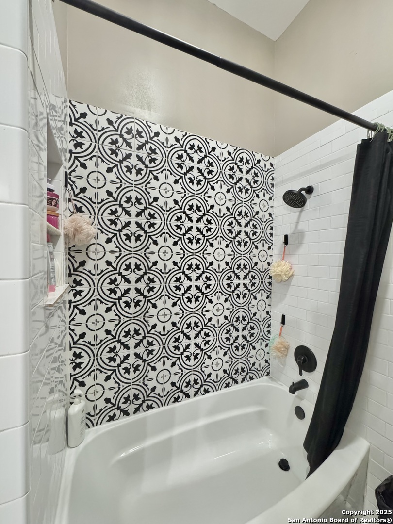 1106 North High Street Uvalde, TX 78801 - Photo 9 of 26 a bathroom with a bathtub and shower