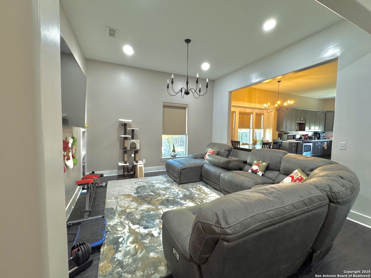 1106 North High Street Uvalde, TX 78801 - Photo 10 of 26 a living room with furniture kitchen and a chandelier