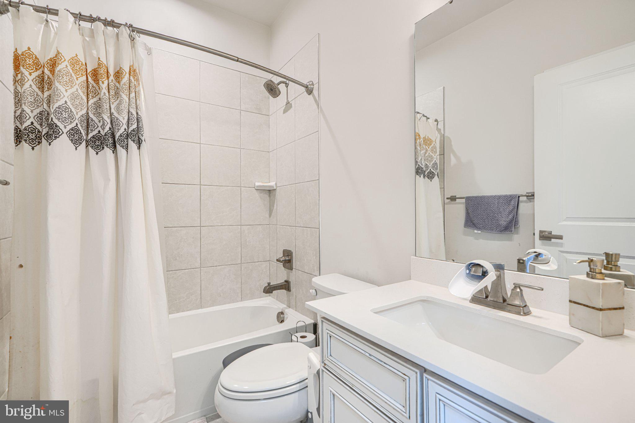 1510 Decatur Street Baltimore, MD 21230 - Photo 14 of 27 a bathroom with a sink a toilet and shower