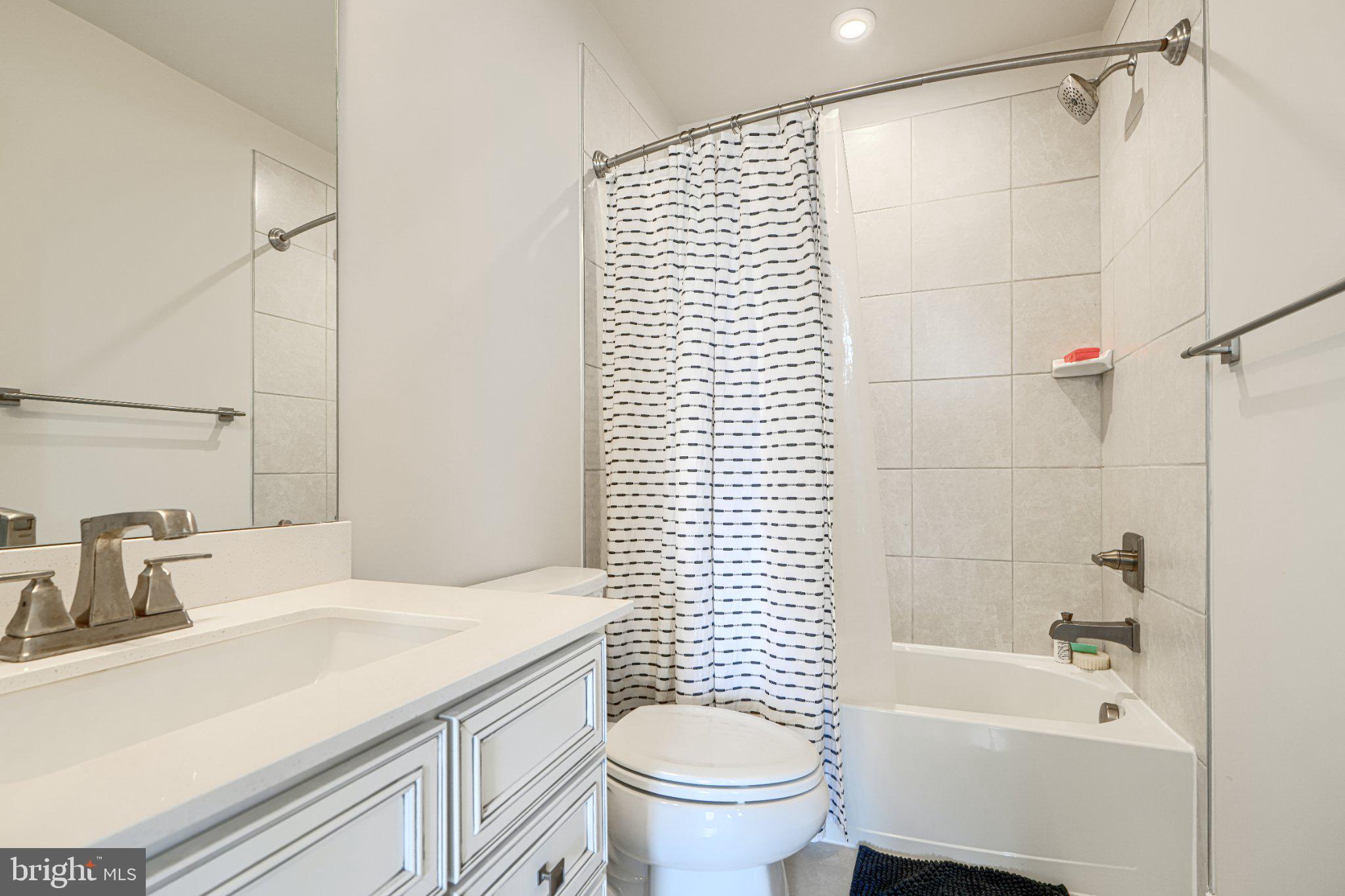 1510 Decatur Street Baltimore, MD 21230 - Photo 24 of 27 a bathroom with a sink a toilet and shower