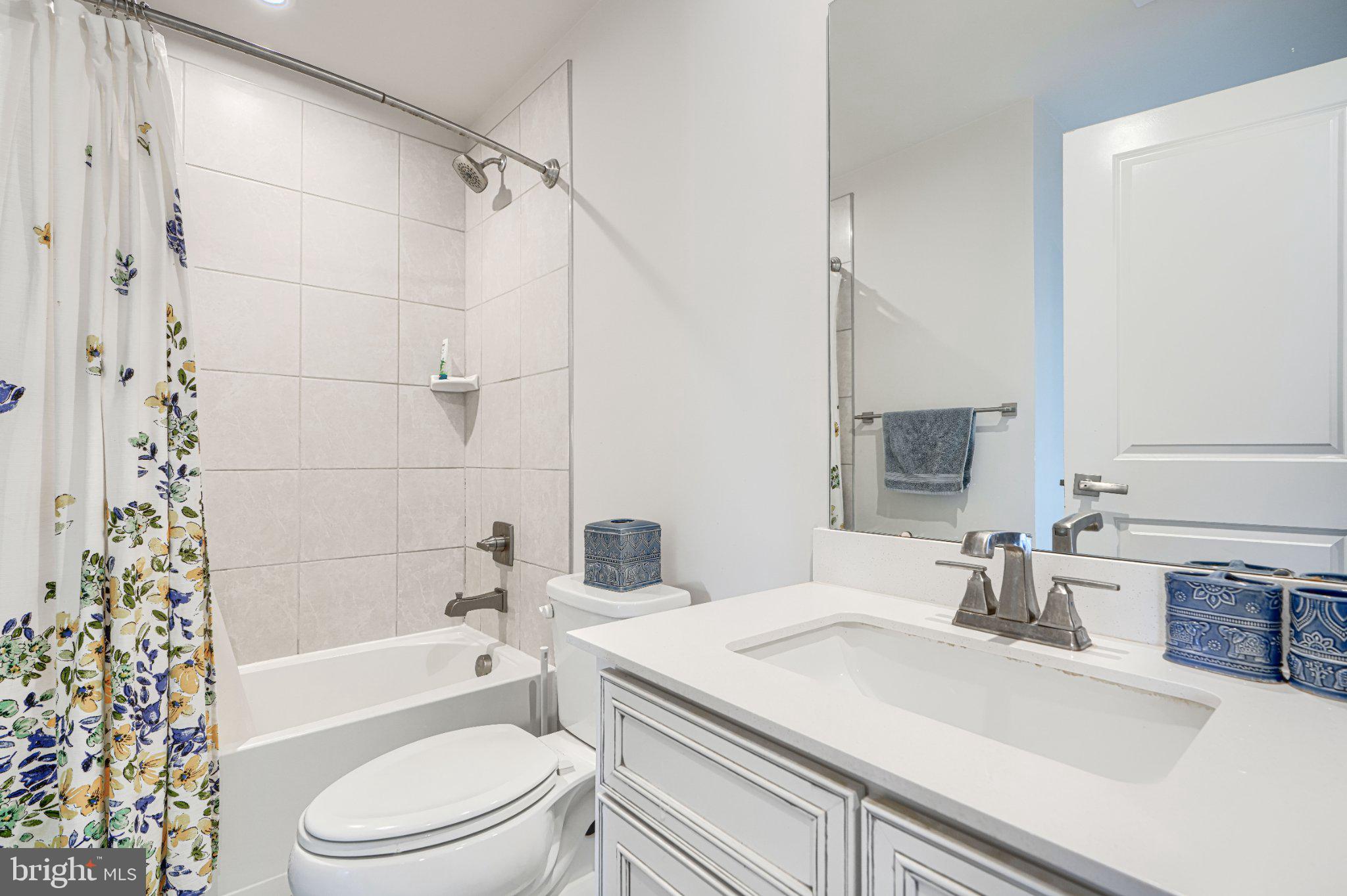 1510 Decatur Street Baltimore, MD 21230 - Photo 4 of 27 a bathroom with a sink a toilet a vanity and bathtub