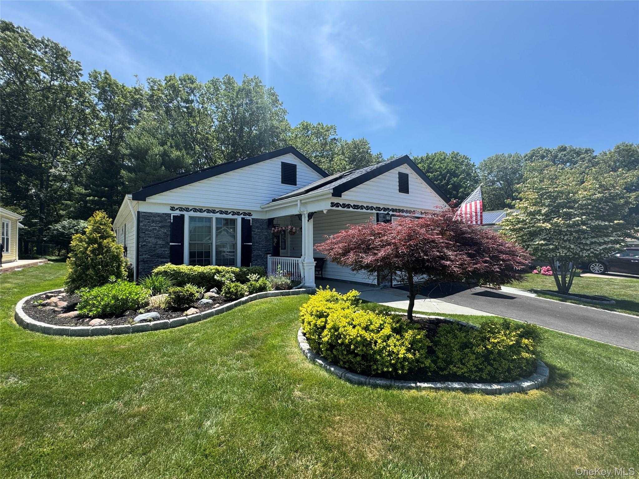 525 Cranston Lane Ridge, NY 11961 - Photo 1 of 1 a front view of a house with a yard fire pit and outdoor seating