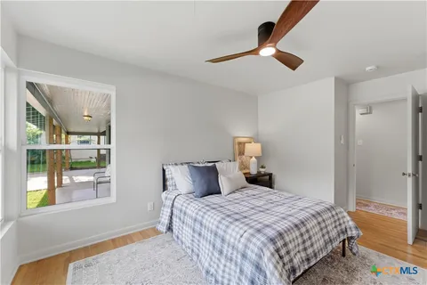 a bedroom with a bed and window