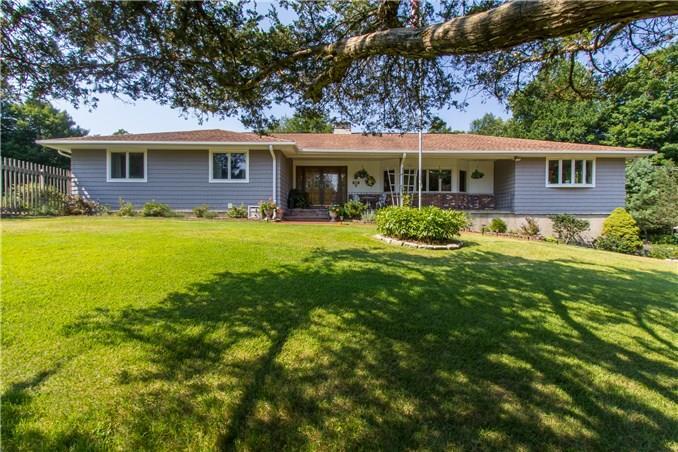 26 Chipmunk Lane Ridgefield, CT 06877 - Photo 1 of 1 a front view of a house with a garden