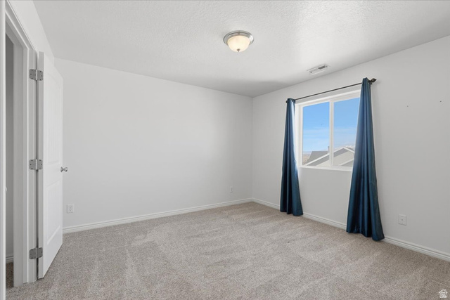 1218 Moonlight Drive Elk Ridge, UT 84651 - Photo 26 of 44 Empty room with light carpet and a textured ceiling