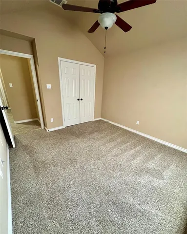 a view of an empty room with a ceiling fan