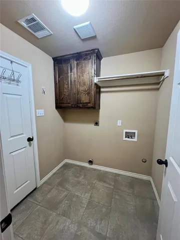 a view of a storage & utility room with a refrigerator
